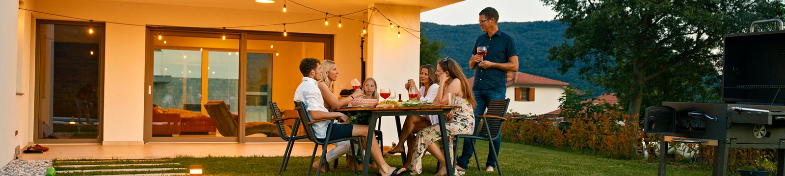 family in backyard having bbq