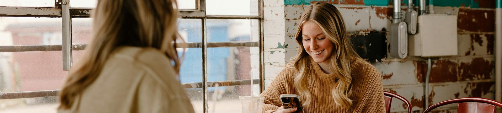 female friends using their phone